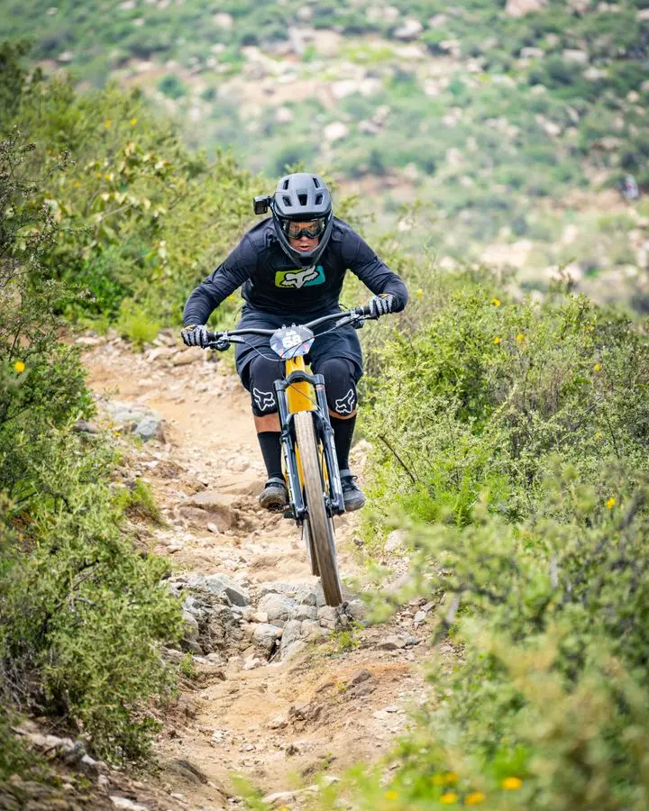 A focused cyclist rides a rugged mountain trail, showcasing determination and the thrill of outdoor biking.