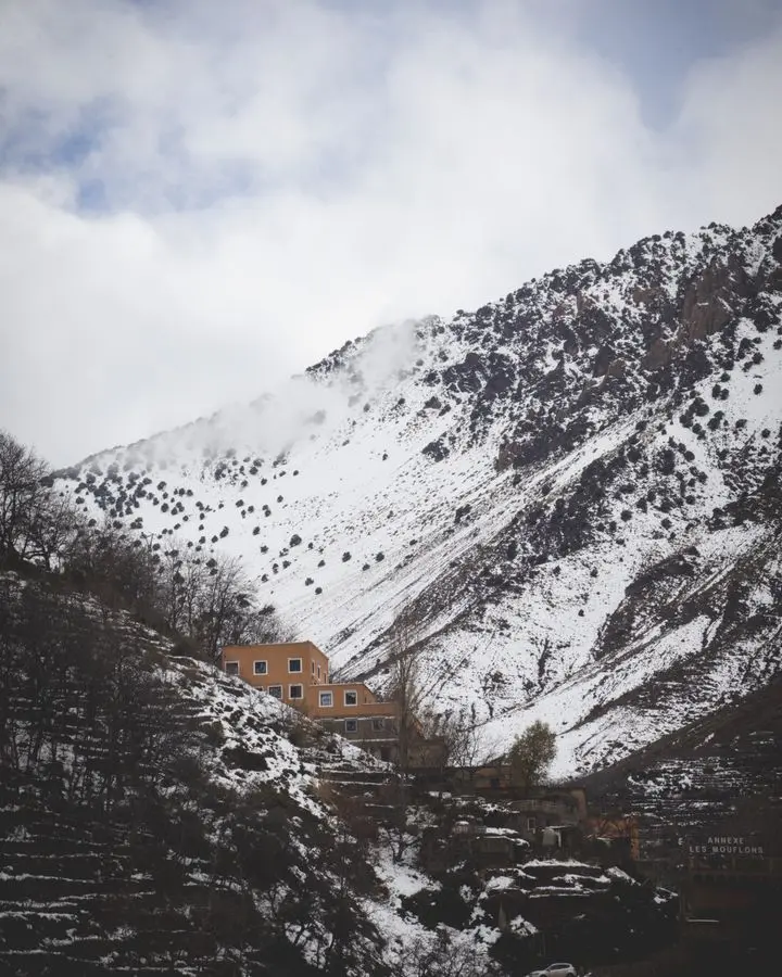 Scenic winter landscape of a snowy mountain village in Imlil, Morocco.