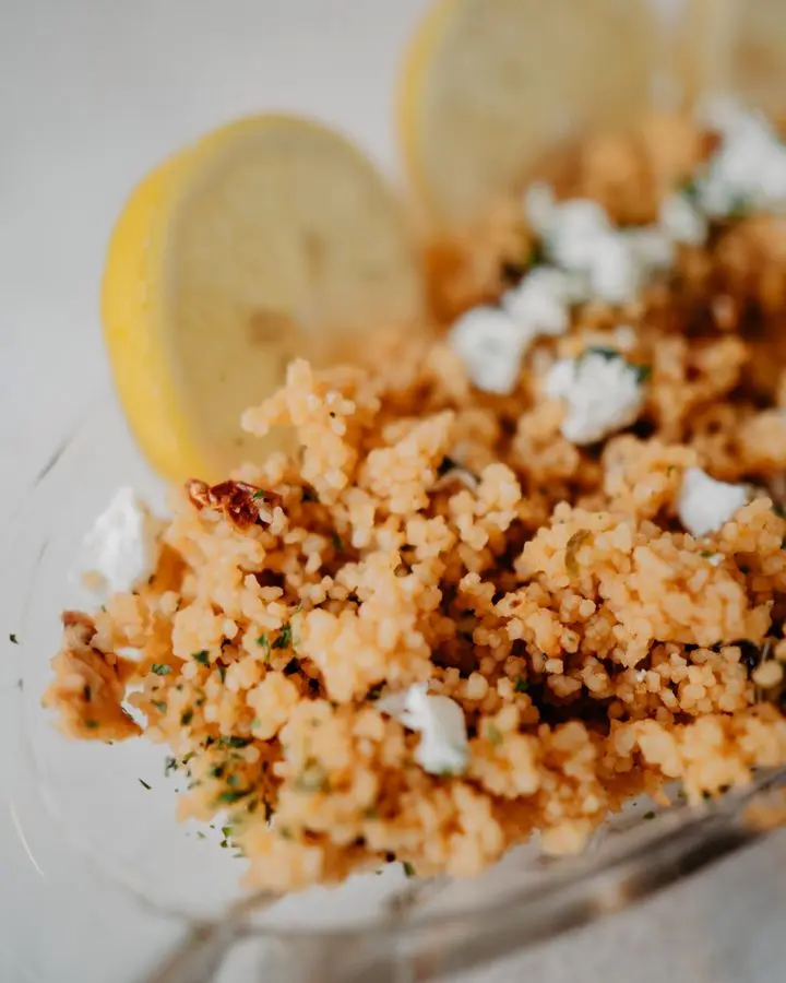 Savory couscous dish garnished with lemon slices and herbs, perfect for a homemade meal.