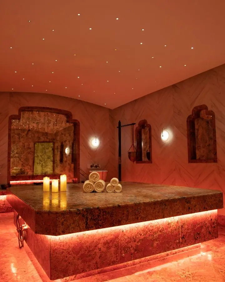 Exquisite Turkish bath in Delhi with warm lighting, towels, and candles.