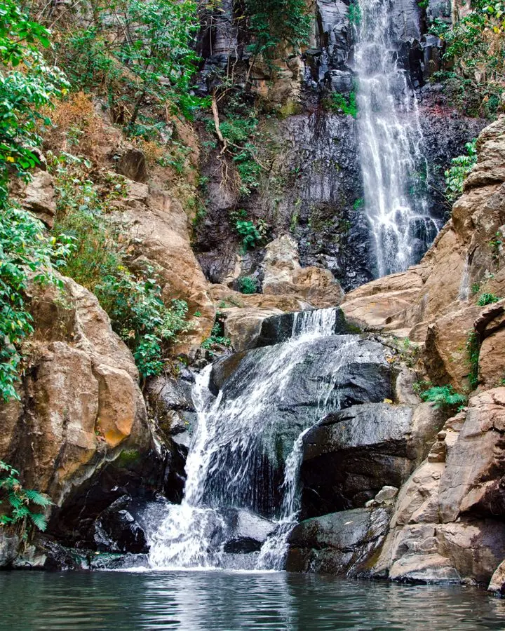 Beautiful cascading waterfall surrounded by lush greenery in Tequila, Mexico.