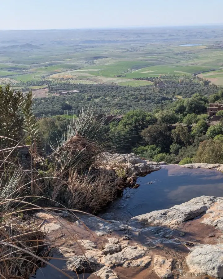 Breathtaking landscape view over Aguergour, Marrakech-Safi, with lush greenery and rocky foreground.