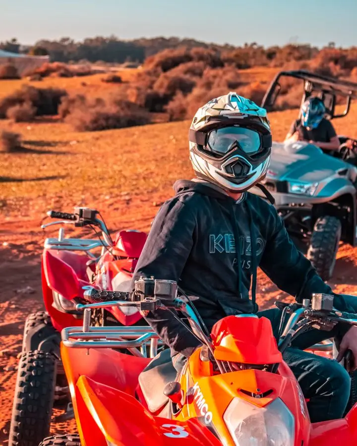 Experience the thrill of quad biking with helmets in Morocco's vast desert landscape.